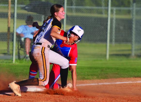 Tecumseh sophomore Madison Gray tries to protect third base as a Lady Lion slides onto it during the sixth inning of the Sept. 30 home game with Chandler. The Lady Savages won, 3-2. Countywide &amp;amp; Sun/Natasha Dunagan