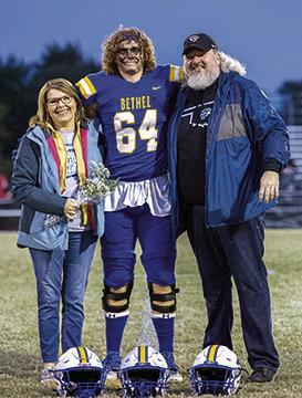 Carla and Thomas Tollett pose with their Bethel senior, Alex Tollett, during Senior Night ceremonies before the home football game on Oct. 28. Photo provided by Richelle Treece.