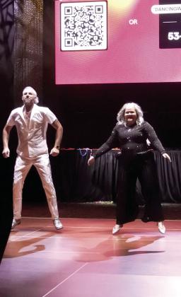 Bobby Licklider and Cama Watts bounce across the dance floor in a lively routine.