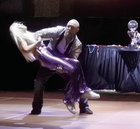 Emergency Management Director Aaron Scott flips County Commissioner Melissa Dennis while jiving to some decades music during the Dancing With Shawnee event on Thursday, Sept. 4 at the Grand Casino.