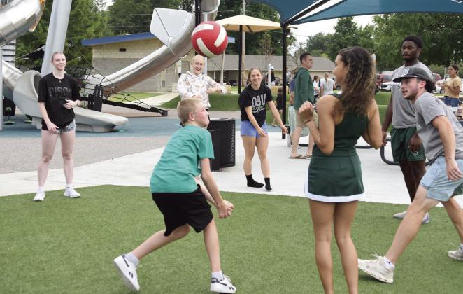 Brent Wallace (green shirt), 13, and sister Zoey (sweatshirt), 12, play with OBU athletes from volleyball, cheer and football.