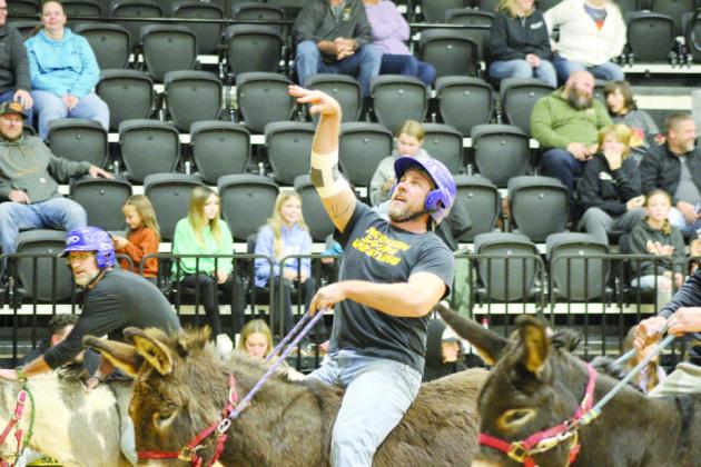 Tecumseh High School Head Wrestling Coach Billy Don Sigman sinks his shot during the Tecumseh Tip In Club Donkey Basketball fundraiser.