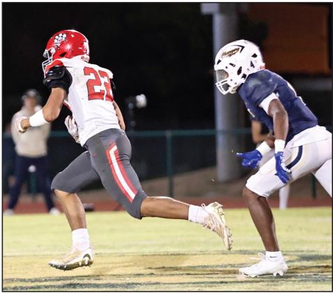 North Rock Creek’s CaleP Hawkins crosses into the endzone for a Cougar touchdown. Photo courtesy of Gowin Photography