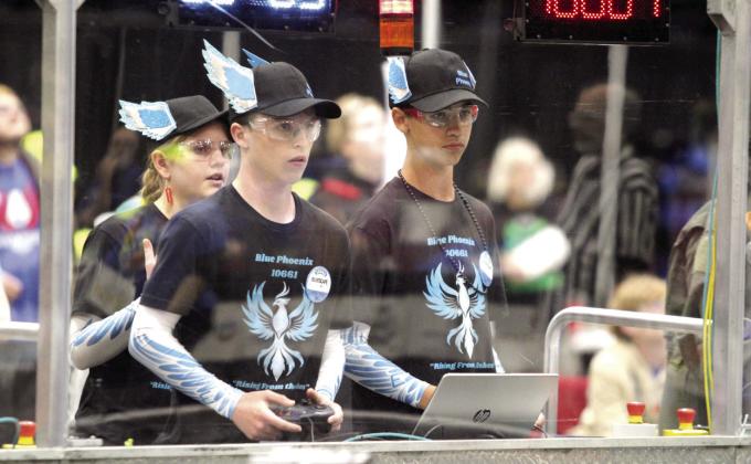 Grove School eighth-graders Emma Knight, Conner Vorndran and Daniel Bowlan watch over and control their robot, Sapphira, during the Oklahoma Regionals FIRST Robotics Competition, held at FireLake Arena on April 5. They are members of the new community robotics team called Blue Phoenix, which is housed at OBU and led by Lori Farris, a teacher at Grove. Natasha Dunagan, Countywide &amp; Sun