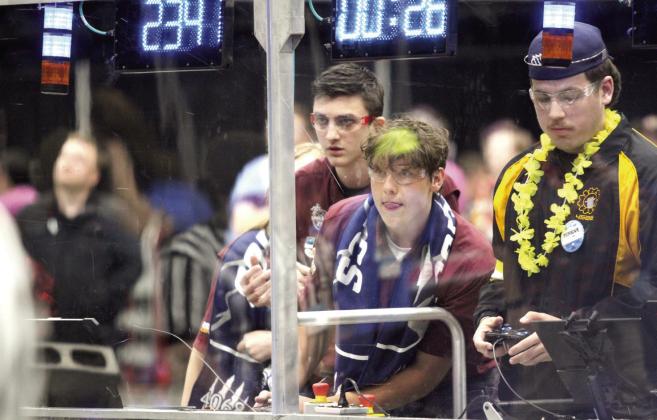 Sprockets Robotics Team members Miles Buss and Zach Nowakowski watch over and work the controls of their robot, 'Tsunamic,' formerly 'The Trench,' during the playoffs. Sprockets was in the winning alliance and won the Regional Engineering Inspiration Award. Natasha Dunagan, Countywide &amp; Sun