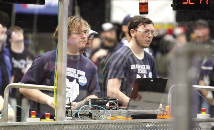 Members of the Shawnee High School Robopack, Hunter Jones and Michael Buchanan work the controls to the 'USS Octobot' during the playoffs. They ended with a rank of 29 out of 48 teams, but they were chosen by the captain of Alliance 4 to be on their team for the playoffs and made it to Match 13 out of 14. Natasha Dunagan, Countywide &amp; Sun