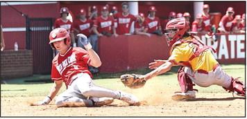 North Rock Creek's Mavrick Wingo slides past the Dale catcher to score the first run for the Cougar's. Photo courtesy of Gowin Photography