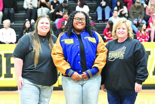 Tecumseh High School 2025 graduate Kiara Stallin received her All-State Track jacket during the homecoming games on Jan. 30. Also shown are former track coach Montana Palmer, left, and Track and Cross-Country Coach Kortney Ozment. Photo courtesy of Kenetta Lisenbee