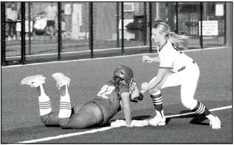 Shawnee freshman Abi Clements tries to tag a Glenpool runner who was diving back to third base in the game against Glenpool, held at FireLake Ball Fields on Sept. 19. The Lady Wolves lost, 0-14.