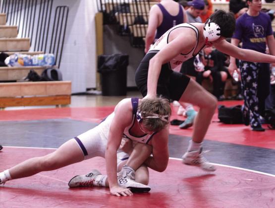 McLoud's Easton Tiffin gets his leg caught by a Mannford wrestler. McLoud also faced Harrah and Cushing.