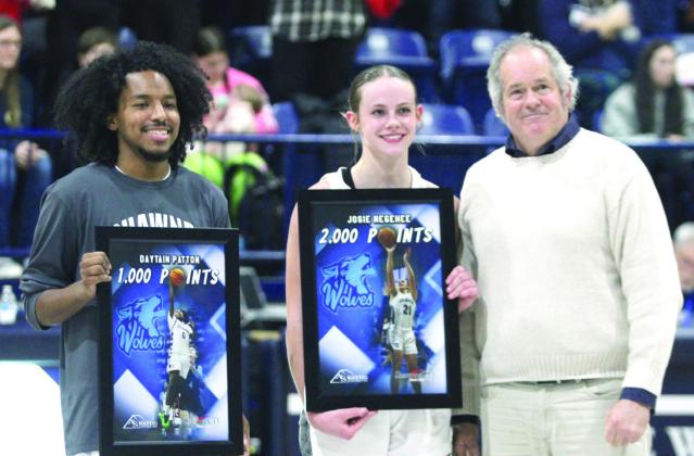 Daniel Shaughnessy, with Shawnee CTV, presents framed pictures to Shawnee seniors Daytain Patton, who has reached 1000 points, and Josie Megehee, who has made 2,000 career points, between games on Feb. 8. Both also received basketballs from the games where they reached their milestones. Countywide &amp; Sun/Natasha Dunagan