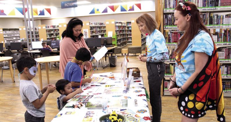 Vonceil Harmon and Heather Rowell, far right, with Okies for Monarchs offer information, wildflower seeds and coloring sheets to a mother and her children during Bugfest at the Shawnee Public Library on May 30. Okies for Monarchs, which formed in 2016, is a nonprofit and part of the Oklahoma Monarch Society, and Harmon is a biologist for the Oklahoma Department of Transporation. For more information, visit okiesformonarchs.org.