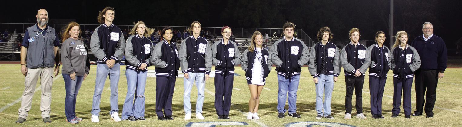 Sponsored by Arvest Bank, academic letter jackets were presented to 11 Shawnee seniors during half-time of the home football game on Nov. 3. Shown, from left, are Shawnee High School Principal Matt Johnson, Arvest representative Jill Rawls, Titus Wright, Eva Webb, DezaRae Simmons, Cruz Merrell, Scottland Meier, Mia Jennings, Cole Hodges, Matthew Ellis, Luke Dyer, Chiara Carpenter, Keilani Anderson and Arvest Community Bank President Brian Nave. Countywide &amp;amp; Sun/Natasha Dunagan