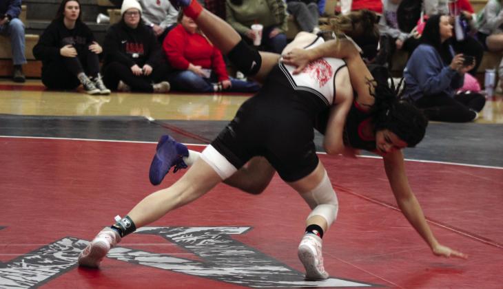 McLoud's Launa Troutt picks up and flips her Mustang opponent during the McLoud Redskin Rumble Girls Dual Championship on Jan. 20. McLoud High School hosted 16 teams for the fourth annual event. Broken Arrow was the final winner by criteria, after tying Bixby, 36-36, said McLoud Girls Wrestling Coach William Winters. McLoud was in the consolation bracket, having beaten Union, 51-24, and Mustang, 48-30, but falling to Del City, 30-39. Countywide &amp; Sun/Natasha Dunagan