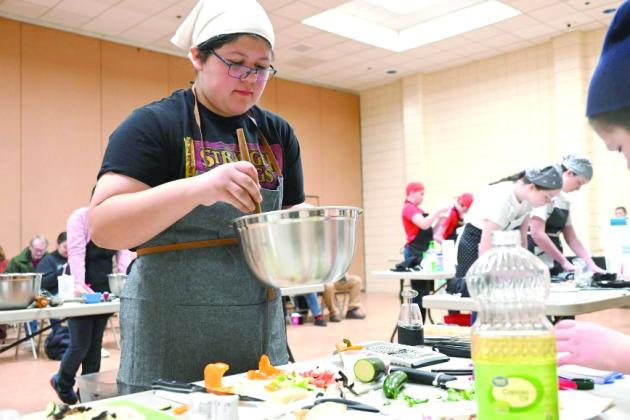 Ciara Vance from Scissortail 4-H is mixing ingredients. Photo provided