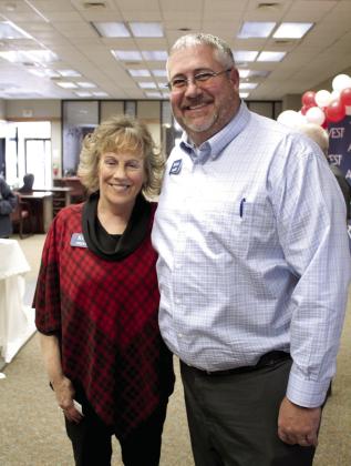 Kim Rawls poses with Arvest Community Bank President Brian Nave during her retirement reception on Dec. 30. Rawls worked for the bank for 43 years. Countywide &amp;amp; Sun/Natasha Dunagan