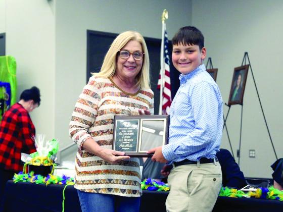 Gabe Hobbs, North Rock Creek 4-H, receives the Outstanding Junior 4-H Award. The award is presented by Jamie Barrick on behalf of the award sponsor, The Clinic Pharmacy. Photo provided