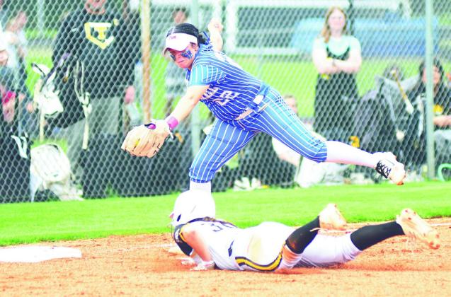 Bethel junior Alexis Williams tries to tag Tecumseh junior Cadence Leba as she dives for third base. Photo courtesy of Brian Blancett
