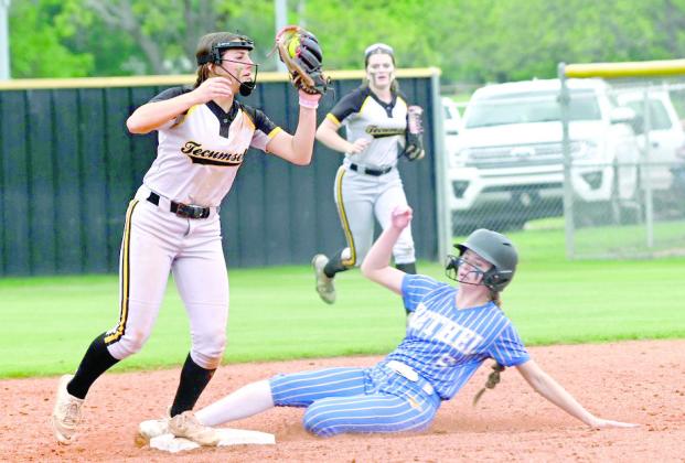 Tecumseh junior Cadence Leba makes the catch as Bethel sophomore Kinley Bowles slides into first base, losing a shoe Photo courtesy of Kenetta Lisenbee