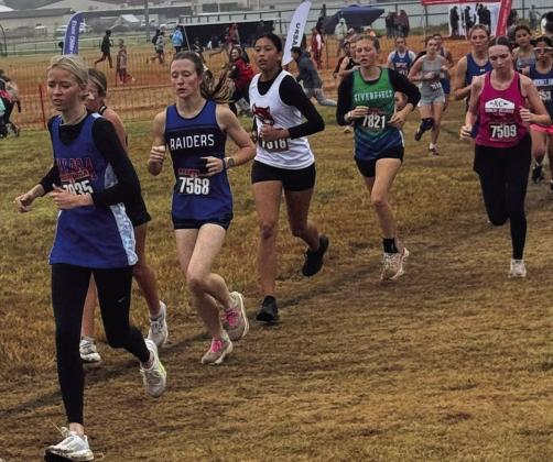 Earlsboro Junior Aha Roubidoux (white jersey) runs in the State Cross Country Track Meet hosted by North Rock Creek on Oct. 25. Photo Provided