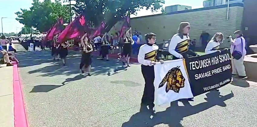 Brylan Babilon, Harrison Wooten, and Madelyn Hughes, carry the Tecumseh Savage Pride Band banner ahead of the marching band at the Oklahoma State Fair Marching Band Parade Contest on Sept. 15. Photo Provided