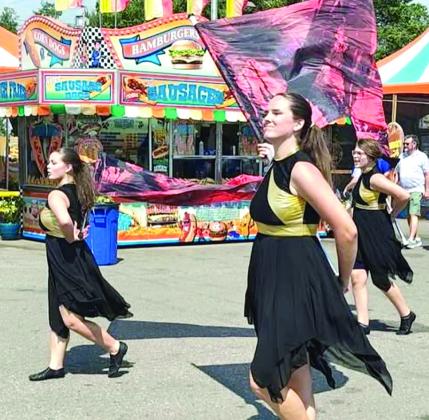 Color Guard members, Emma Wilson , Adelaide Lack and Kaitlyn Stell, perform at the Oklahoma State Fair on Sept. 15. Photo Provided