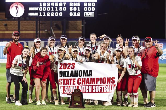 North Rock Creek’s Slow Pitch Softball team pose with the 5A State Championship banner and trophy. Photos courtesy of Gowin Photography