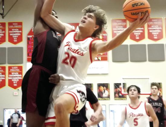 Dale’s Casen Richardson goes up for a layup against an Oklahoma Christian Academy defender. The Pirates beat OCA 76-37 to move on to the semi-finals. Countywide &amp;amp; Sun/Suzie Campbell