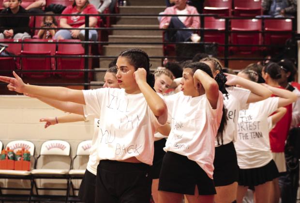 The Earlsboro High School Cheerleaders mime shooting a bow while a Varnum player shoots a free throw during the Nov. 7 girls' home game. Shown in front are Glendine Trolinger and Jesslyn Williams.