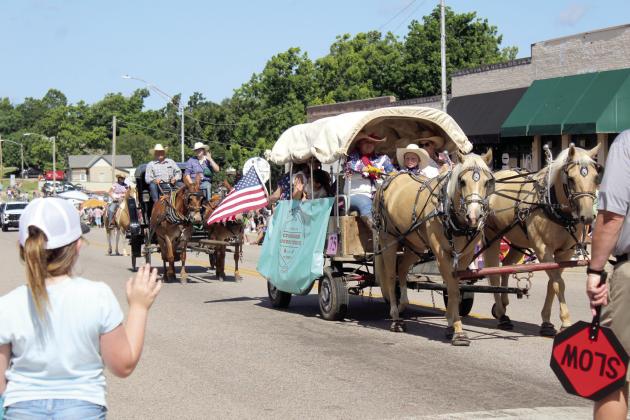 A covered wagon and a carriage from Crossroads Cowboy Church in Harrah make their way east on Broadway Ave. during the McLoud Blackberry Festival Parade on June 21. There were 75-80 entries in the parade, said Melanie Krause with the McLoud Chamber of Commerce.