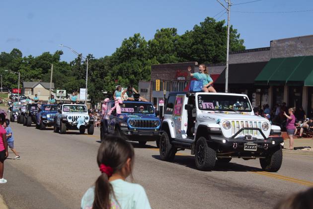 A long line of Jeeps carrying McLoud Blackberry Festival pageant contestants, led by Charlotte Reith, head east on Broadway Ave. during the festival parade on June 21. There were 75-80 entries in the parade, said Melanie Krause with the McLoud Chamber of Commerce.