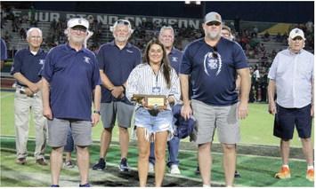 Creed Humphrey’s parents accept a plaque inducting Humphrey into the Shawnee Hall of Fame during halftime of the Sept. 1 home game, held at OBU. Shawnee 2017 graduate Humphrey was unable to attend, as he is gearing up for the Kansas City Chiefs season, but he sent a video of himself. Shown, front row from left, is Kelly Parsons, Melissa Humphrey and Chad Humphrey, back row, Bill Ford, Mike Hawkins, Chris Reynolds, Greg Petree, and Don Keeton. Countywide &amp; Sun/ Natasha Dunagan