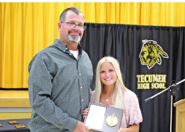Tecumseh senior Lauren Taylor accepts the THS Outstanding Female Athlete of the Year Award from Coach Chad Trahan. Taylor received the Gary Guinn Memorial Scholar Athlete Award, as well.