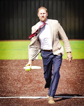 Superintendent Blake Moody throws out the first pitch on North Rock Creek's new softball turf field, March 30.