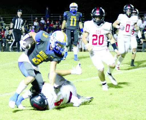 Bethel senior Brady Lower tries to deflect a Crossings Christian defender - who still trips him up - as he runs the ball at the homecoming game on Oct. 20. The Wildcats lost, 26-39.