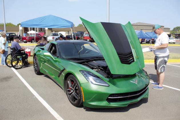 Cheer grampa and volunteer Ian Formanski, right, judges a 2015 Corvette Stingray, owned by Eric and Karri Brunk of Shawnee.