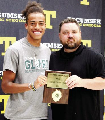 Tecumseh Football Coach Ty Bullock, right, presents the Male Savage of the Year Award to Marquan Krush during the Tecumseh High School Athletic Awards on May 15. Bullock said Krush personifies "so many good things that have nothing to do with football." Countywide &amp; Sun/Natasha Dunagan