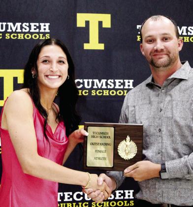 Tecumseh Head Girls Basketball Coach Eldon Gentry, right, presents the Outstanding Female Athlete Award to senior Kenzli Warden during the Tecumseh High School Athletic Awards on May 15. Gentry said Warden has a passion to win in both basketball and track and is an "amazing person and athlete." Warden recently set a school record in the long jump and took second in that event at the State Track Meet, according to the THS Facebook page. Countywide &amp; Sun/Natasha Dunagan