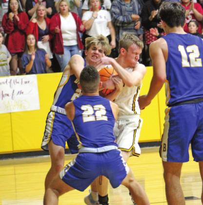 Bethel’s Xavier Meier and Tecumseh’s Ben Corley fight for possession during the Tecumseh home game on Dec. 3. Bethel won 77-56.