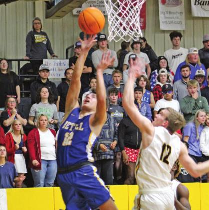 Bethel’s John Gordon shoots for two as Tecumseh’s Ben Corley plays defense during the Tecumseh home game on Dec. 3.