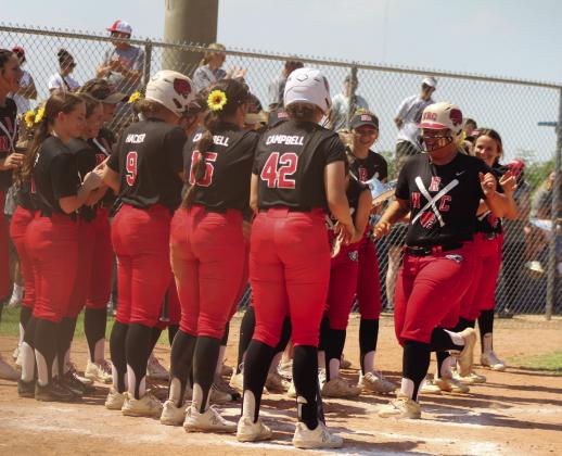 North Rock Creek’s Hannah Earlywine is congratulated for her home run in the second inning of the Class 5A Slow Pitch State Semifinals with Tecumseh on April 30. The #1-ranked Lady Cougars won in their Quarterfinals with Perkins-Tryon, 10-9, but lost to the #2-ranked Lady Savages in the Semifinals, 7-13. Their record this season is 33-9.