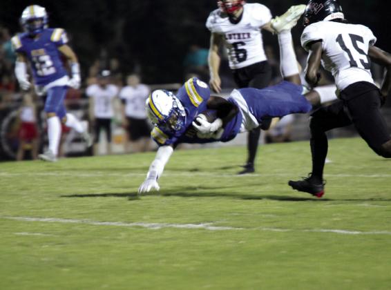 Bethel junior Ezra Powis dives to gain yardage during the Sept. 6 home game against Luther. The Wildcats had a rough start with a 6-25 loss.