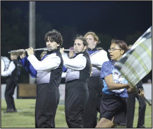Pride of Bethel band members Cayden Ricker, Nathan Ricker, and Elijah Robertson perform music from the Blues Brothers, as color guard member Patience Steli dances around them with her flag, during the Sept. 6 football game halftime. File photo