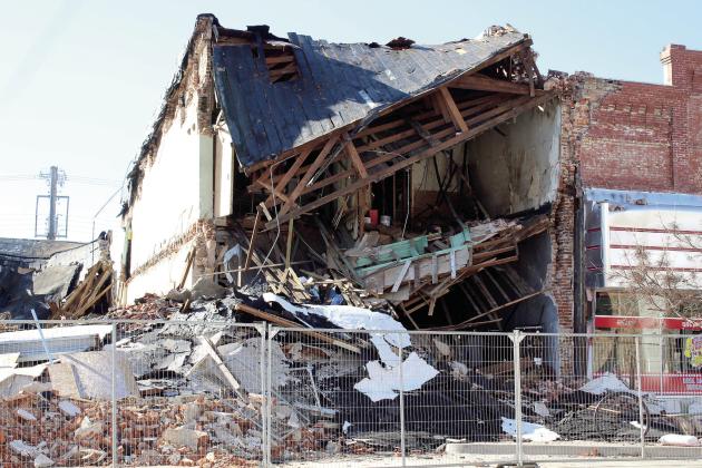 The Past to Present Marketplace stands in rubble after its neighboring building on the corner of Broadway and Main was demolished on Jan. 24. One of its co-owners was decorating inside the front windows when the demolition began and left before the building collapsed. Countywide &amp; Sun/Natasha Dunagan