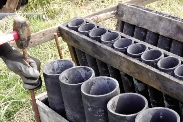 The racks are built out of wood to keep the tubes upright. They are then placed in v-shapes and zip-tied together, then secured into the ground with rebar.