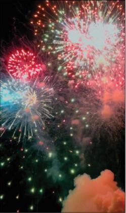 As the grand finale lights up the sky, you are able to see a plume of smoke hangs in the air just below the the skyline.