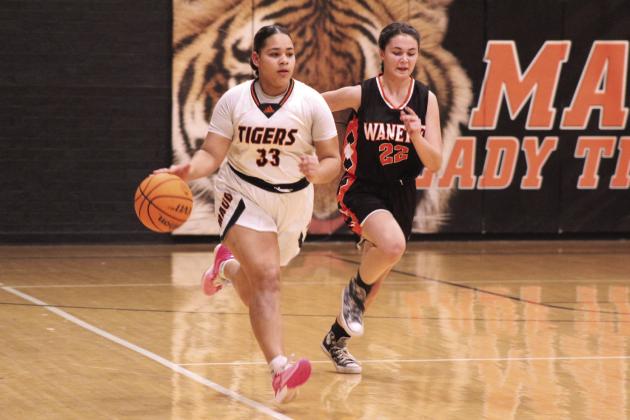 Maud’s Amerikus Street takes the ball up the court followed by Wanette’s Cala Tankslay in the third quarter of the Jan. 26 homecoming game. File photo