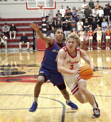 Dale junior Denton Forsythe drives to the basket during the Jan. 17 homecoming game against Millwood. The Pirates won, 64-57. Countywide &amp; Sun/Jessica Jones