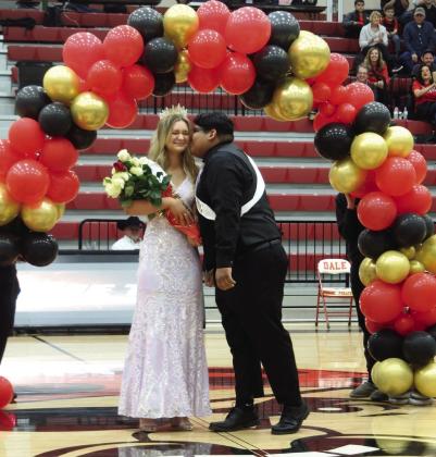 Dale senior and basketball manager Inasio Garza gives Dale Spring Homecoming Queen Heartly Snyder a peck on the cheek during the ceremony on Jan. 17. Countywide &amp; Sun/Suzie Campbell