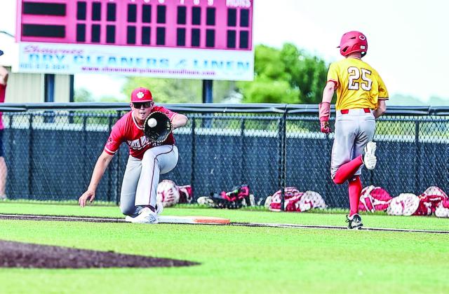 Grady Gates stretches for the ball and get Dax Herring out.